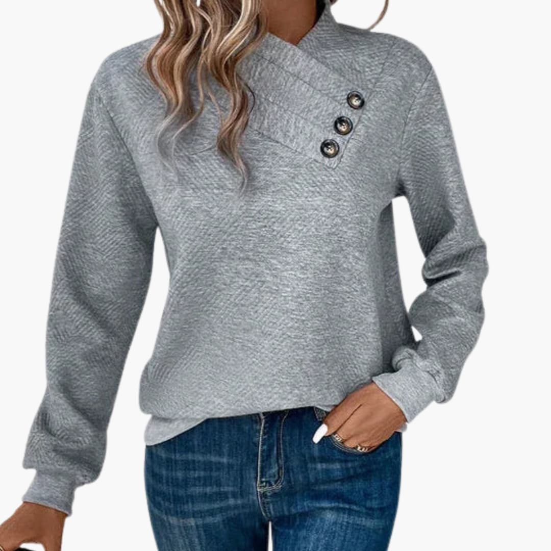 Pull femme à col asymétrique avec bouton décoratif